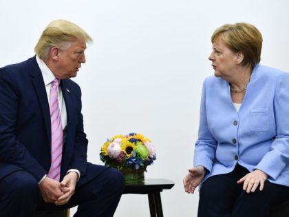 US President Donald Trump (L) attends a meeting with Germany's Chancellor Angela Merkel during the G20 Osaka Summit in Osaka on June 28, 2019. (Photo by Brendan Smialowski / AFP) (Photo credit should read BRENDAN SMIALOWSKI/AFP via Getty Images)