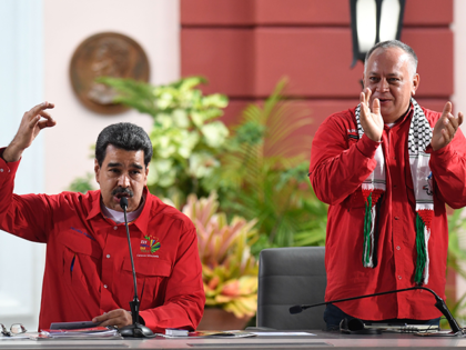 Venezuelan President Nicolas Maduro (L) speaks as the president of the Venezuelan National