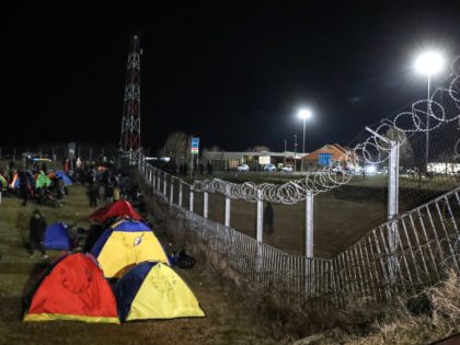 Migrants camp in tents next to the border fence at the Serbian Kelebija border village nea