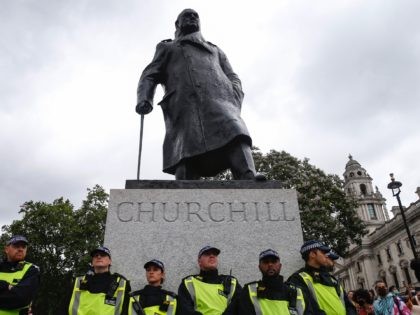 LONDON, ENGLAND - JUNE 27: Police guard a statue of Winston Churchill in Parliament Square during two Black Trans Lives Matter protests on June 27, 2020 in London, England. The Black Trans Lives Matter march was held to support and celebrate the Black transgender community and to protest against potential …