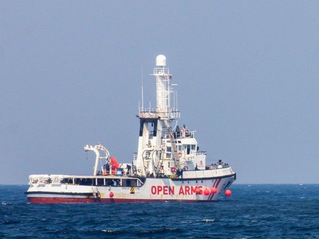 A patrol boat (R) of the Italian Coast Guards (Guardia Costiera) sails past the rescue vessel of Spanish NGO Open Arms (L) on September 17, 2020 off the port of Palermo, Sicily, after another patrol boat of the Guardia Costiera rescued a group of 76 migrants who threw themselves into …