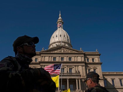 LANSING, MI - SEPTEMBER 17: Second Amendment protesters listen to gun-rights advocates speak about the importance of the second amendment during a rally on the Michigan Capitol Building lawn on September 17, 2020 in Lansing, Michigan. Second Amendment protesters filled the lawn of the Michigan State Capitol to protest restrictions …