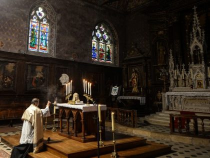 French priest Olivier Monnier prays during an afternoon Eucharistic adoration in Saint-Jacques Church in Illiers-Combray, western France, on November 15, 2020, as mass celebrations are banned as part of restrictions during France's second national lockdown aimed at curbing the spread of the Covid-19 pandemic, caused by the novel coronavirus. (Photo …