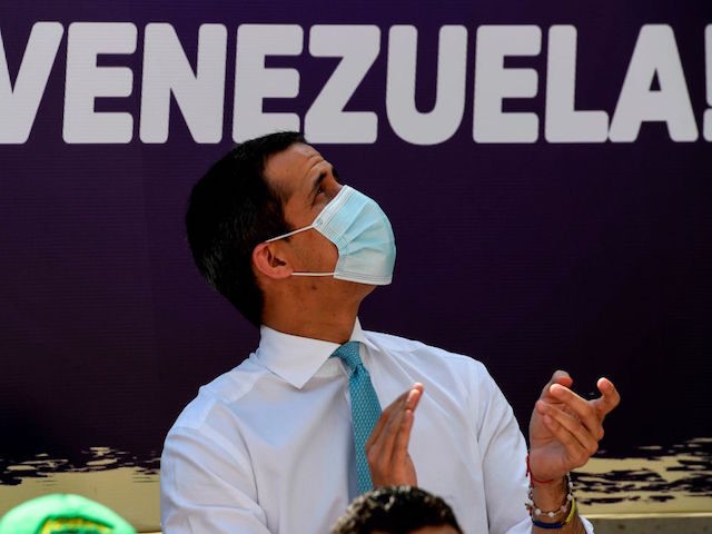 Venezuelan opposition leader Juan Guaido applauds during the closing of the campaign for a