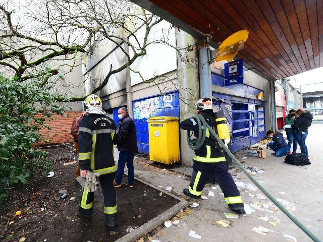 Firemen intervene at a post office which burned on the New Year's Eve, in the working-class neighborhood of Aubiers, in Bordeaux, on January 1, 2021, where bus and streetcar stops has also been destroyed and where the forces of order wiped out "a rain" of fireworks mortars and projectiles the …