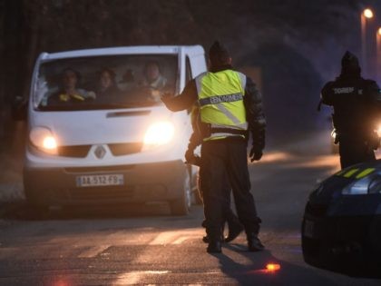 French Gendarmes stop a van at a checkpoint after breaking up a dance rave near a disused hangar in Lieuron about 40km (around 24 miles) south of Rennes, on January 2, 2021. - Some 2,500 partygoers attended an illegal New Year rave in northwestern France, violently clashing with police who …