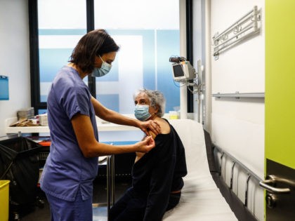 TOPSHOT - A nurse administers a dose of the Pfizer-BioNTech Covid-19 vaccine at the hospit