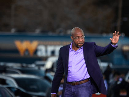 Democratic US Senate candidate Reverend Raphael Warnock arrives to speak at a rally at Garden City Stadium in Savannah, Georgia on January 3, 2021. - The two candidates are competing in a runoff election on January 5th that will decide which party controls the United States Senate. (Photo by Logan …