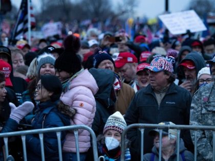 People wait for a rally of supporters of US President Donald Trump challenging the results of the 2020 US Presidential election on the Ellipse outside of the White House on January 6, 2021 in Washington, DC. - Joe Biden's Democratic Party took a giant step Wednesday towards seizing control of …