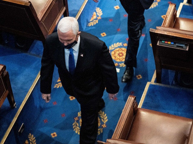 Vice President Mike Pence walks off the House floor during a joint session of Congress to