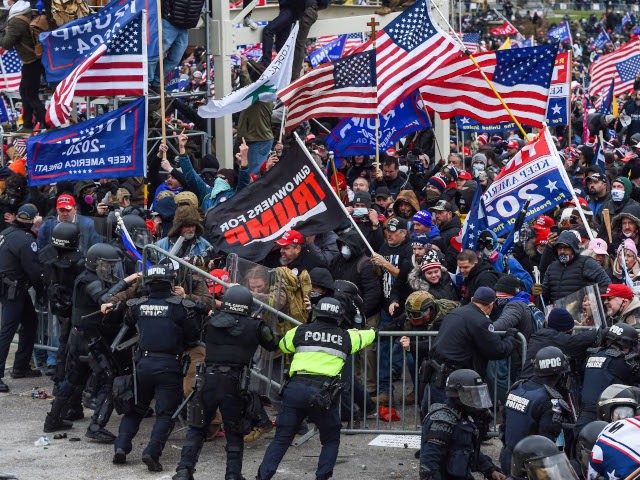 Trump supporters clash with police and security forces as they storm the US Capitol in Washington, DC on January 6, 2021. - Demonstrators breeched security and entered the Capitol as Congress debated the a 2020 presidential election Electoral Vote Certification. (Photo by ROBERTO SCHMIDT / AFP) (Photo by ROBERTO SCHMIDT/AFP …