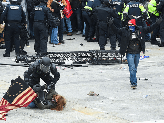 Trump supporters clash with police and security forces as they storm the US Capitol in Washington, DC on January 6, 2021. - Demonstrators breeched security and entered the Capitol as Congress debated the a 2020 presidential election Electoral Vote Certification. (Photo by ROBERTO SCHMIDT / AFP) (Photo by ROBERTO SCHMIDT/AFP …
