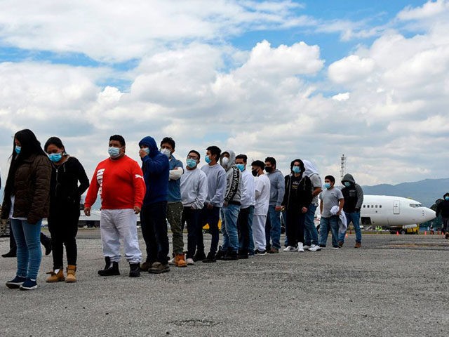 Guatemalan migrants deported from the United States, queue upon their arrival at the Air F