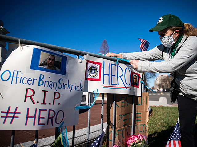 Anne Seymour, a crime victim advocate, creates a makeshift memorial for U.S. Capitol Polic