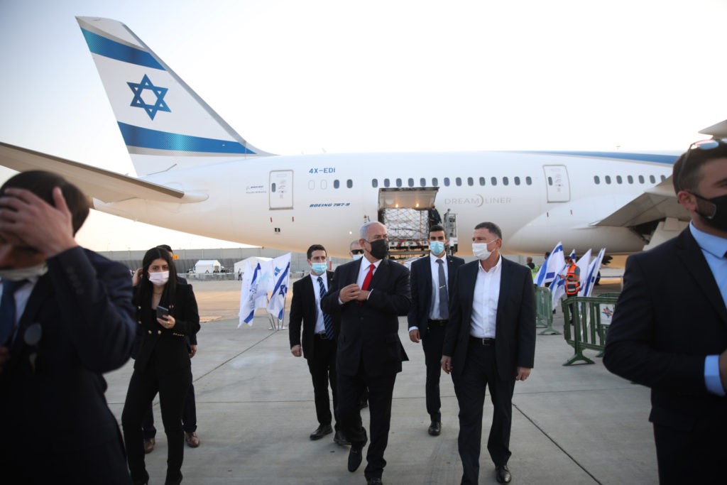 Israel’s Prime Minister Benjamin Netanyahu (C-L) and Health Minister Yuli Edelstein (C-R) attend a ceremony for the arrival of a plane carrying a shipment of Pfizer-BioNTech anti-coronavirus vaccine, at Ben Gurion airport near the Israeli city of Tel Aviv on January 10, 2021. Netanyahu announced earlier this week that he had signed a deal for enough doses of the Pfizer-BioNTech vaccine for all Israelis over 16 to be innoculated. (MOTTI MILLROD/POOL/AFP via Getty Images)