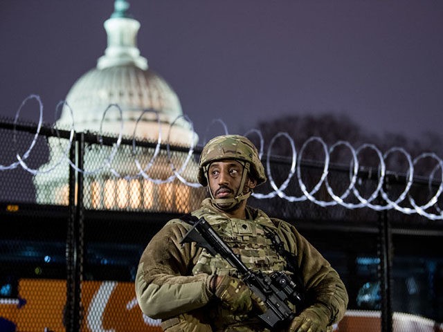 WASHINGTON, DC - JANUARY 15: VA National Guard stands outside the razor wire fencing that surrounds the US Capitol on January 15, 2021 in Washington, DC. After last week's Capitol Riot the FBI has warned of additional threats against the US Capitol and in all 50 states. According to reports, …