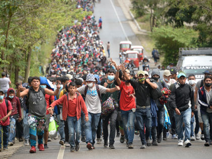 Honduran migrants, part of a caravan heading to the United States, walk along a road in Camotan, Guatemala on January 16, 2021. - At least 4,500 Honduran migrants pushed past police and crossed into Guatemala Friday night, passing the first hurdle of a journey north they hope will take them …