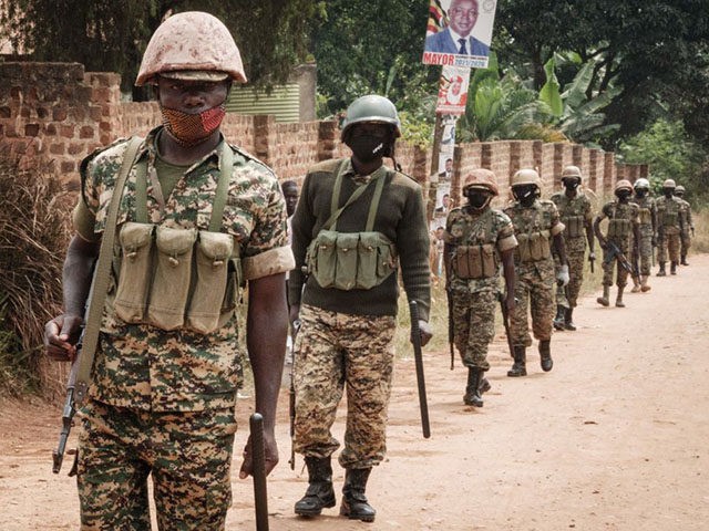 Ugandan soldiers patrol near the street leading to the house of Robert Kyagulanyi, also kn