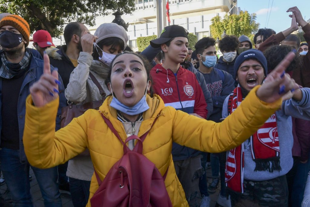 Tunisian protesters shout slogans during an anti-government demonstration on the Habib Bourguiba avenue in the capital Tunis, on January 19, 2021. Tunisia braced for further protests after hundreds were arrested in four nights of street clashes between riot police and disaffected youths in cities across the North African country. (FETHI BELAID/AFP via Getty Images)