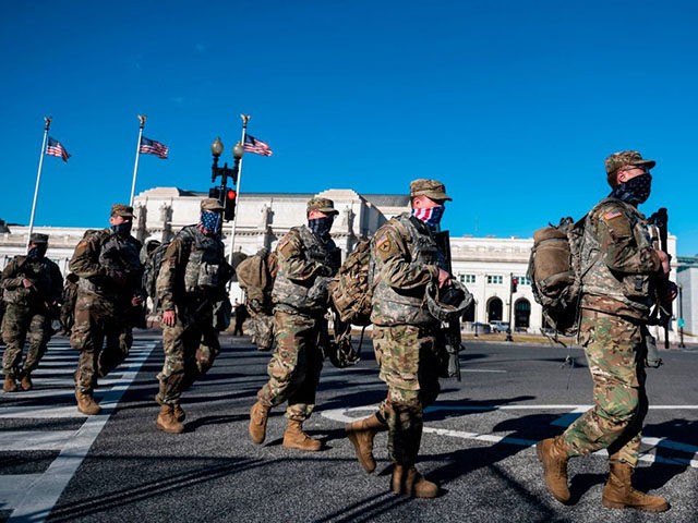 Members of the US National Guard walk outside of Union Station as they deploy to the US Capitol on January 19, 2021 in Washington, DC, ahead of the 59th inaugural ceremony for President-elect Joe Biden and Vice President-elect Kamala Harris. (Photo by ANDREW CABALLERO-REYNOLDS / AFP) (Photo by ANDREW CABALLERO-REYNOLDS/AFP …