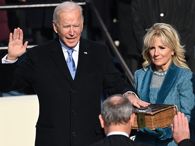 US-POLITICS-INAUGURATION Joe Biden (L), flanked by incoming US First Lady Jill Biden is sworn in as the 46th US President by Supreme Court Chief Justice John Roberts on January 20, 2021, at the US Capitol in Washington, DC. (Photo by SAUL LOEB / POOL / AFP) (Photo by SAUL LOEB/POOL/AFP via …