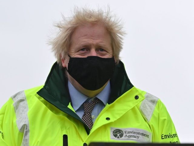 Britain's Prime Minister Boris Johnson reacts as during his visit to a storm basin ne