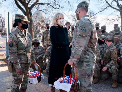 TOPSHOT - Saying, The Bidens are a National Guard family, first lady Jill Biden greets members of the National Guard with chocolate chip cookies outside the Capitol on January 22, 2021, in Washington, DC.  (Photo by Jacquelyn Martin / POOL / AFP) (Photo by JACQUELYN MARTIN/POOL/AFP via Getty Images)