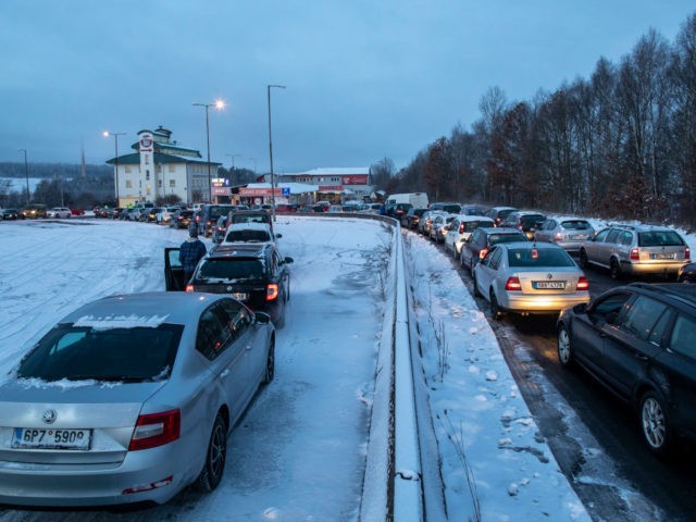 PRAGUE, CZECH REPUBLIC - JANUARY 25: People, many of them Czechs on their daily commute to their workplace in Germany, wait in line for a rapid COVID test near the Czech-Germany border during the second wave of the coronavirus pandemic on January 25, 2021 in Pomezi nad Ohri, Czech Republic. …