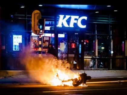 TOPSHOT - A vehicle has been set on fire after a large group of young people has sought confrontation with the police on Beijerlandselaan in Rotterdam, on January 25, 2021. - The Netherlands was hit by a second wave of riots on January 25 evening after protesters again went on …