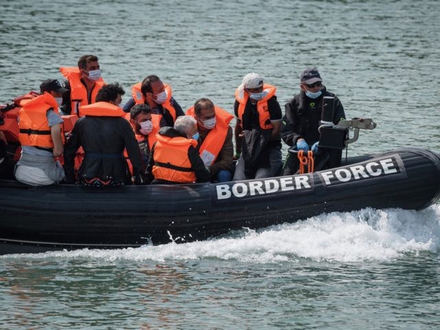 DOVER, ENGLAND - AUGUST 11: Migrants arrive in port aboard a Border Force vessel after being intercepted while crossing the English Channel from France in small boats on August 11, 2020 in Dover, England. In recent weeks large numbers of migrants have travelled in small boats across the English channel, …
