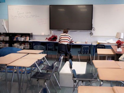 CHICAGO, ILLINOIS - SEPTEMBER 08: Hannah Chorley, a teacher at King Elementary School, sits in an empty classroom teaching her students remotely during the first day of classes on September 08, 2020 in Chicago, Illinois. Students at King Elementary and the rest of Chicago public schools started classes today remotely …
