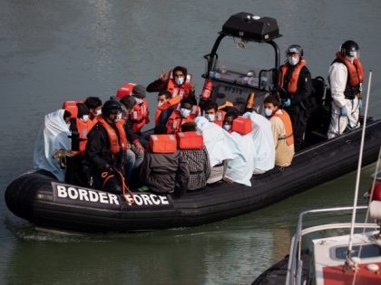 DOVER, ENGLAND - SEPTEMBER 22: Border Force officials unload migrants, that have been intercepted in the English Channel, in order to process them on September 22, 2020 in Dover, England. This summer has seen an increase in people making the journey in small crafts from France seeking asylum in U.K. …
