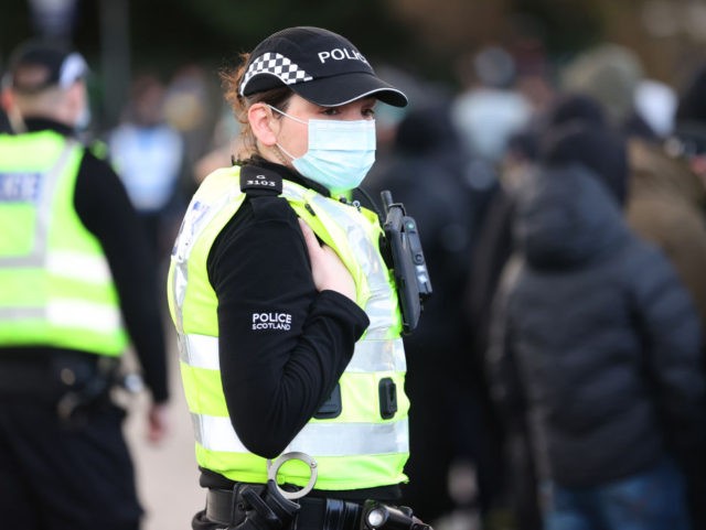GLASGOW, SCOTLAND - DECEMBER 20: A Police officer wearing a protective mask is seen outside the stadium prior to the William Hill Scottish Cup final match between Celtic and Heart of Midlothian at Hampden Park National Stadium on December 20, 2020 in Glasgow, Scotland. The match will be played without …