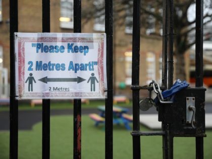 LONDON, ENGLAND - JANUARY 04: A social distancing sign hangs on a primary school gate in t
