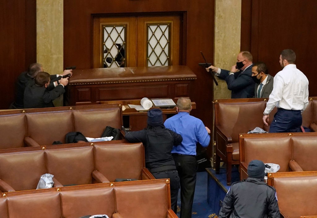 U.S. Rep. Troy Nehls (blue shirt) stands with Capitol Police to defend the entrance to the House Chamber. (Photo by Drew Angerer/Getty Images)1