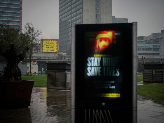 MANCHESTER, UNITED KINGDOM - JANUARY 13: A government pandemic poster looks over the near