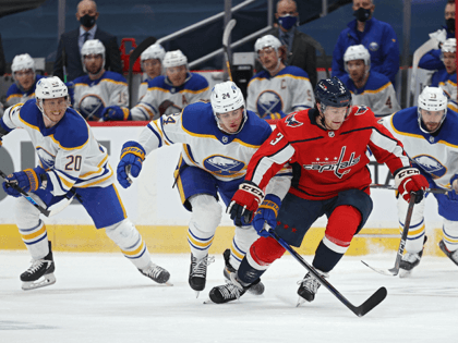 Nick Jensen #3 of the Washington Capitals skates past Dylan Cozens #24 of the Buffalo Sabres during the first period at Capital One Arena on January 22, 2021 in Washington, DC. (Photo by Patrick Smith/Getty Images)
