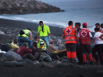 Members of the Red Cross tend to would-be immigrants upon their arrival in Tazacorte, on the Spanish Canary Island of La Palma, on June 30, 2014. The 12 sub-Saharan migrants, who reached the beach of Los Tarajales in a canoe, have been transferred to the police station of Santa Cruz …