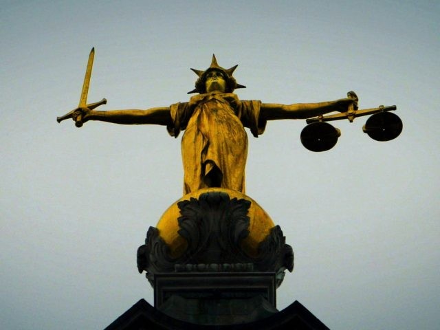 LONDON - DECEMBER 12: A statue of the scales of justice stands high above the Old Bailey on December 12, 2003 in London. Ian Huntley is accused of murdering youngsters Jessica Chapman and Holly Wells, his ex-girlfriend Maxine Carr is accused of conspiring to pervert the course of justice. (Photo …