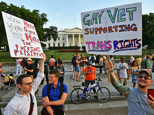Protesters gather in front of the White House July 26, 2017, in Washington, DC. Trump announced on July 26 that transgender people may not serve "in any capacity" in the US military, citing the "tremendous medical costs and disruption" their presence would cause. / AFP PHOTO / PAUL J. RICHARDS …