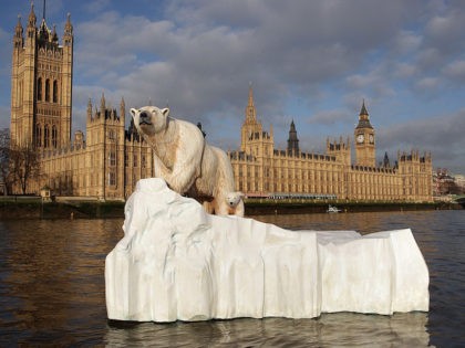 LONDON, ENGLAND - JANUARY 26: A 16 foot high sculpture of a polar bear and cub, afloat on a small iceberg, passes in front of the Houses of Parliament on the River Thames on January 26, 2009 in London, England. The sculpture was launched to provide a warning to members …