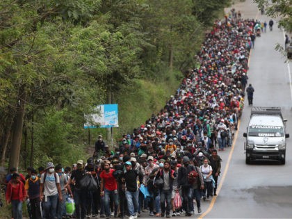 Honduran migrants hoping to reach the U.S. border walk alongside a highway in Chiquimula,