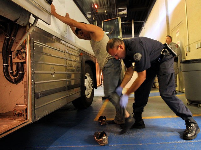PHOENIX - APRIL 28: An undocumented Mexican immigrant is searched while being in-processed at the Immigration and Customs Enforcement (ICE), center on April 28, 2010 in Phoenix, Arizona. Across Arizona, city police and county sheriffs' departments turn over detained immigrants to ICE, which deports them to their home countries. Last …
