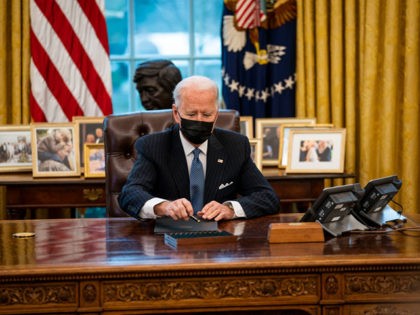 WASHINGTON, DC - JANUARY 25: U.S. President Joe Biden prepares to sign an executive order in the Oval Office of the White House on January 25, 2021 in Washington, DC. President Biden signed an executive order repealing the ban on transgender people serving openly in the military. (Photo by Doug …