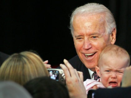 Vice President Joe Biden poses for a photo with an uncooperative baby after his speech at the Florida State University Basketball Training Facility Monday, Feb. 6, 2012, in Tallahassee, Fla. (AP Photo/Phil Sears)