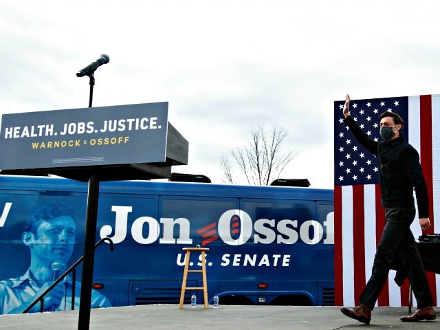 STONECREST, GA - DECEMBER 28: Georgia Democratic Senate candidate Jon Ossoff waves to the crowd gathered for a "It's Time to Vote" drive-in rally on December 28, 2020 in Stonecrest, Georgia. With a week until the January 5th runoff election that will determine control of the Senate, candidates continue to …
