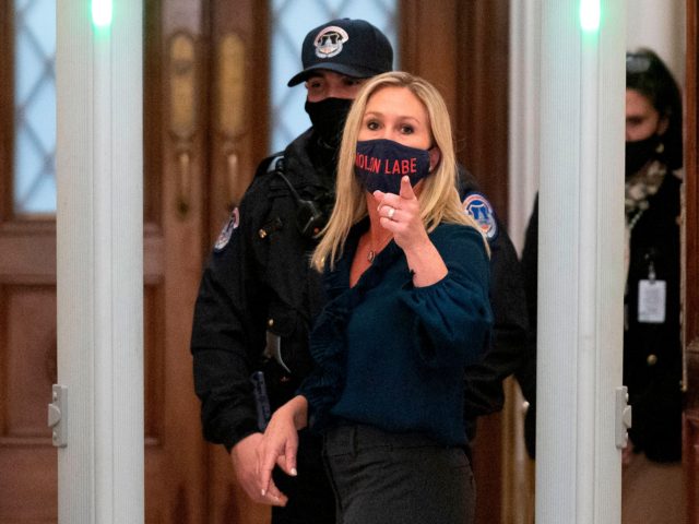 Representative Marjorie Taylor Greene (R-GA) shouts at journalists as she goes through security outside the House Chamber at Capitol Hill in Washington, DC on January 12, 2021. - On the eve of his likely impeachment, President Donald Trump on Tuesday denied responsibility for the storming of Congress by a mob …