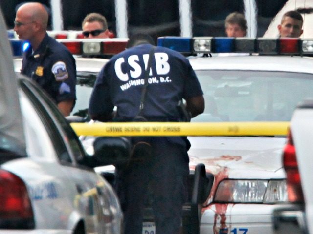 Police technicians survey the crime scene of the fatal shooting near the US Capital, Wednesday, July 15, 2009 in Washington. Police shot and killed an armed man in what authorities described as a routine rush hour traffic stop that turned deadly. (AP Photo/Pablo Martinez Monsivais)