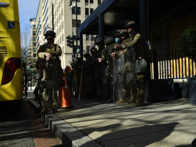 National Guard soldiers prepare to board a bus in Washington, DC, on January 21, 2021, one