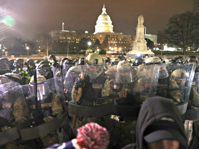 WASHINGTON, DC - JANUARY 06: Members of the National Guard assist police officers in dispersing protesters who are gathering at the U.S. Capitol Building on January 06, 2021 in Washington, DC. Pro-Trump protesters entered the U.S. Capitol building after mass demonstrations in the nation's capital during a joint session Congress …
